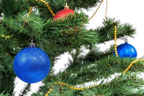 Christmas tree decorated with blue and red balls — Stock Photo, Image