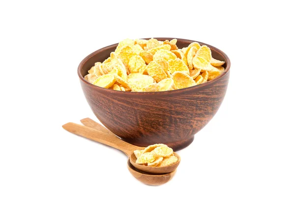 Cornflakes in bowl and wooden spoon. — Stock Photo, Image