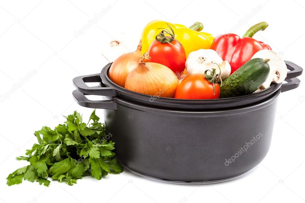 Metal pots and pans with vegetables.