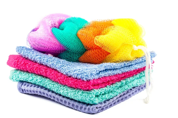 Stack of colored towels and bath sponge. — Stock Photo, Image