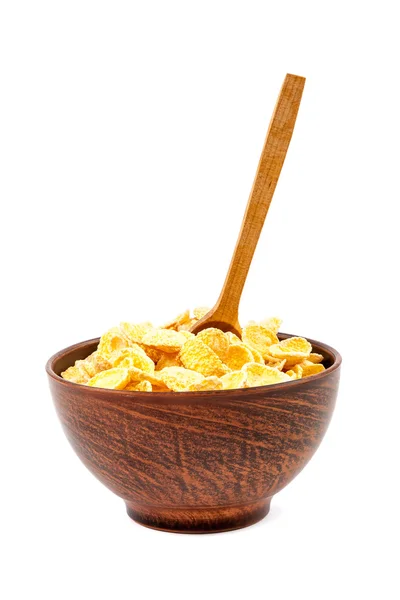 Cornflakes in einer Schüssel aus Keramik und Holzlöffel. — Stockfoto