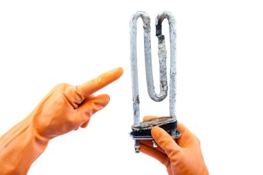 Damaged heating element of the washing machine in hand with rubb clipart