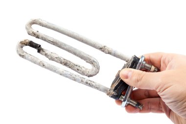 Damaged heating element of the washing machine in a hand. clipart