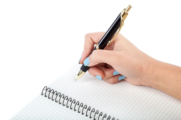 Frauenhand mit einem Stift, der in ein Notizbuch schreibt. Stockbild