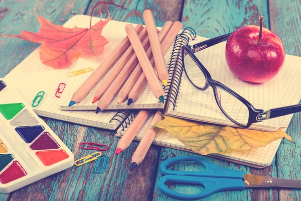 Office or school supplies on wooden planks painted in blue. — Stock Photo, Image