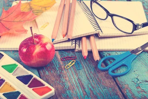 Office or school supplies on wooden planks painted in blue. — Stock Photo, Image