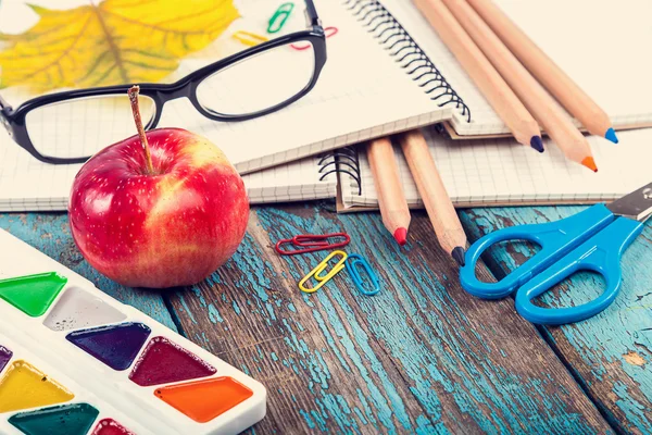 Office or school supplies on wooden planks painted in blue. — Stock Photo, Image