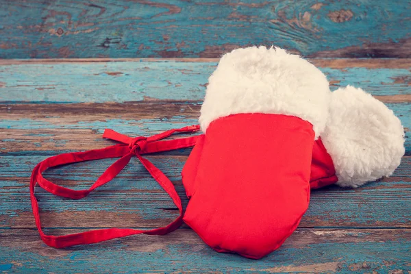 Red mittens with fur on wooden boards. — Stock Photo, Image