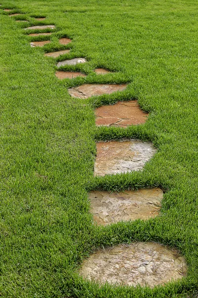 Stone path in green grass. — Stock Photo, Image