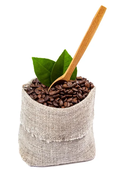 Coffee beans in a sack with a wooden spoon — Stock Photo, Image