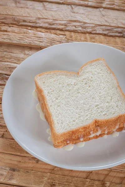 Vintage cup of fresh milk bread with butter — Stock Photo, Image