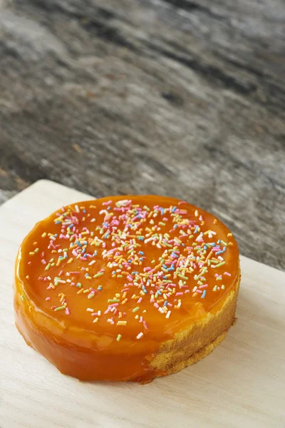 Orange cake on wood plate — Stock Photo, Image