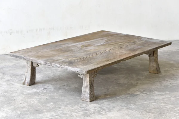 Starožitný dřevěný stůl na zemi — Stock fotografie