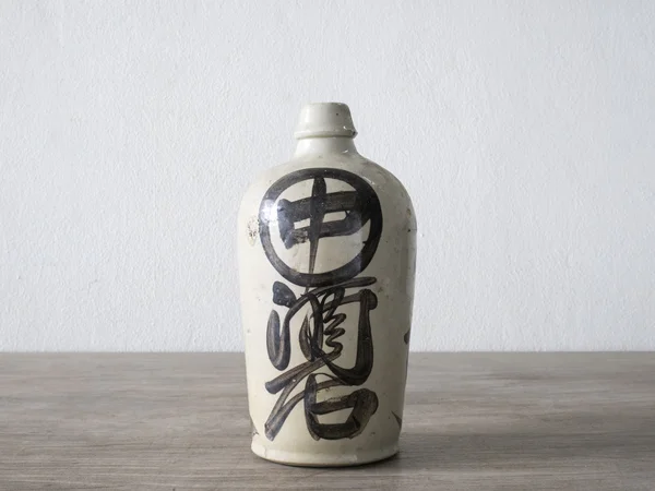 Antique ceramic jar on wood table — Stock Photo, Image