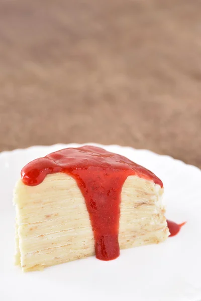 Crepe cake with strawberry syrup — Stock Photo, Image