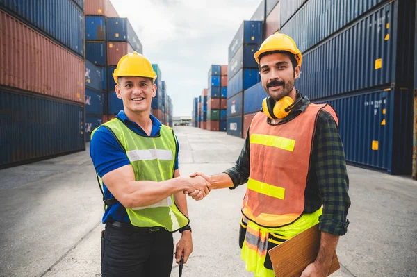 logistic worker teamwork and partner of foreman, engineer, and businessman working in an international shipping area, concept of business industrial and working in container yard to import and export