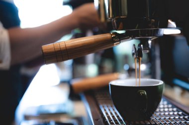Kafedeki espresso kahve makinesi, kahve yapan profesyonel barmen, bir dükkan veya restoranda barın üzerinde bir fincan kafein, modern kahve dükkanı, kahverengi kapuçino içecek üreticisi.