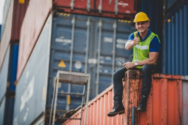 Sanayi lojistik kargo taşımacılığı, ihracat ve ithalat için konteynır terminalinde çalışan mühendis ustabaşı, depo teslimat taşımacılığı, limanda güvenlik kontrolü.