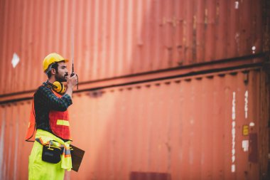 Sanayi lojistik kargo taşımacılığı, ihracat ve ithalat için konteynır terminalinde çalışan mühendis ustabaşı, depo teslimat taşımacılığı, limanda güvenlik kontrolü.