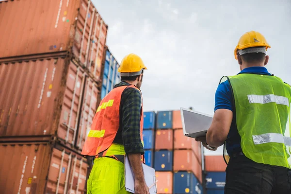 logistic worker teamwork and partner of foreman, engineer, and businessman working in an international shipping area, concept of business industrial and working in container yard to import and export