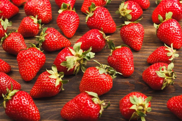 Red strawberries on the wooden background — Stock Photo, Image