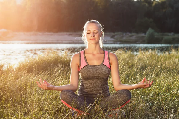 Mujer joven hace ejercicios de yoga — Foto de Stock