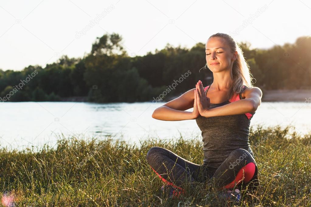 Young woman makes yoga exercises