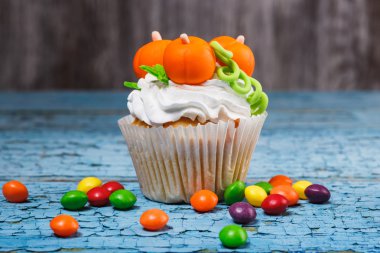 Halloween cupcake with colored decorations clipart