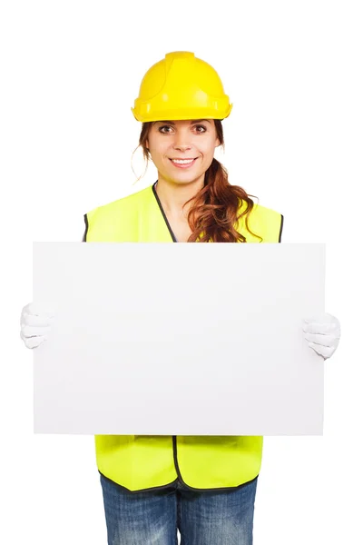 Mujer joven en casco de construcción con placa de identificación —  Fotos de Stock