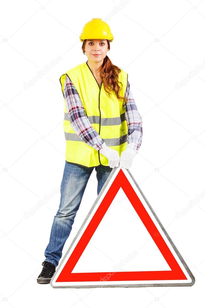 Young woman in construction helmet with road sign