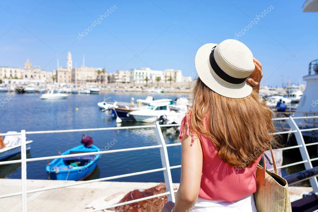 Visiting Bari. Back view of young traveler woman enjoying cityscape of Bari, Italy.