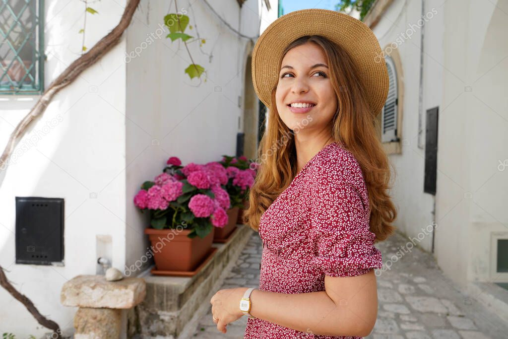 Side view of traveler girl discovering old town and looking away