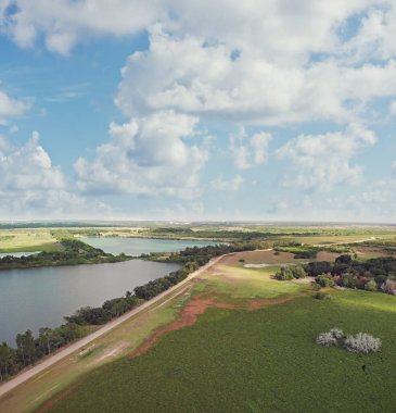 Countryside with a dirt road and lakes. Aerial beautiful landscape.