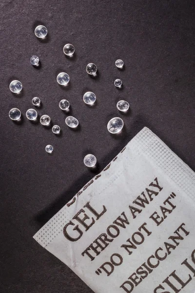 Close up silica gel or desiccant in paper bag on black backgroun — Stock Photo, Image