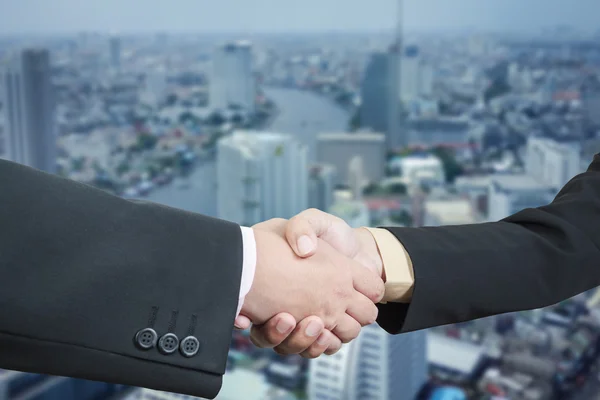 Business handshake with blur background of business buildings ar — Stock Photo, Image