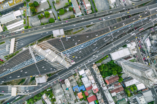 Aerial view of traffic junction and transportation road in city, top and birdeyes view shot 90 degree, blur background