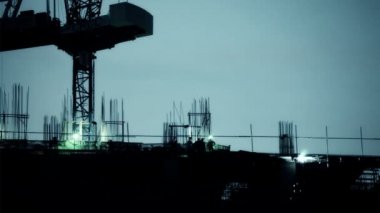 sanayi yerinde inşaat işçisi silueti, gökdelen için bina geliştirme, gün batımı sahnesinde alınan