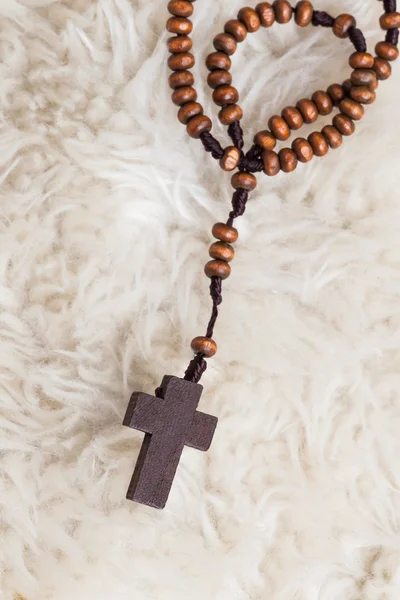 Christian cross necklace on sheep wool, Jesus religion concept a — Stock Photo, Image