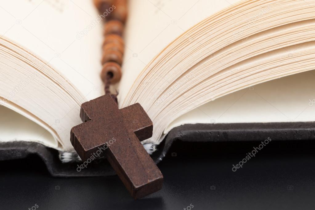 Christian cross necklace on Holy Bible book, Jesus religion conc
