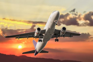 Passenger business airplane take off and flying on sky sunset, u