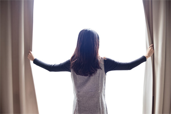 Asian portrait beautiful woman opening curtains