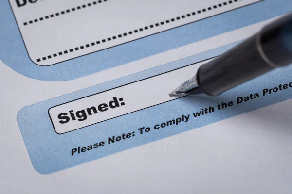 Signature field on document with pen and signed here; document i — Stock Photo, Image