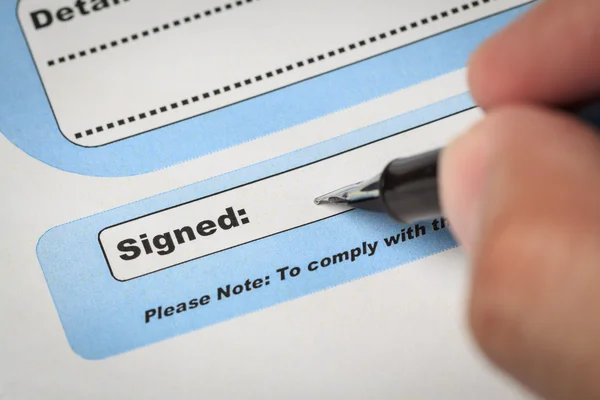 Signature field on document with pen and human hand signed here; — Stock Photo, Image