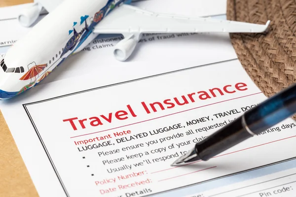 Travel Insurance Claim application form and hat with eyeglass an