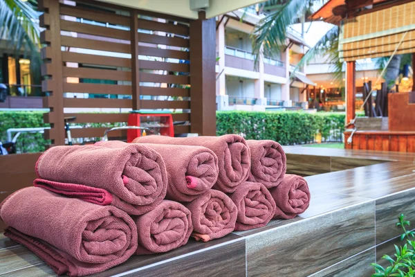 Brown spa towels roll pile for customer service in pool — ストック写真