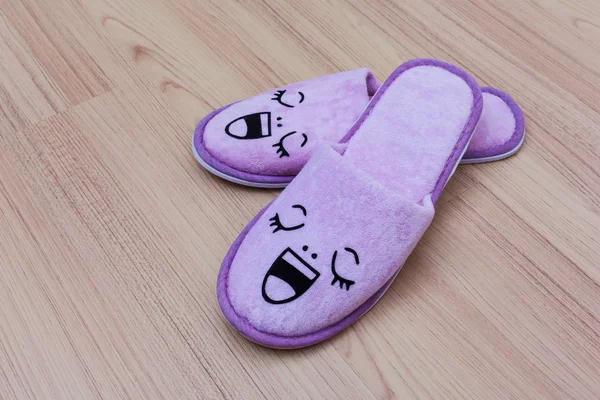 Smile slippers and happy, close up view, on wooden floor — Stock Photo, Image