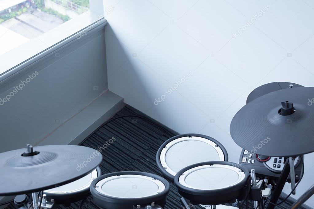 Electronic drum set in the room corner as musical background tec