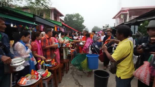 SANGKHLABURI, THAILAND - DECEMBER 27, 2015: Traveler crowd make merit with monk, in morning at Sangkhlaburi District, Kanchanaburi Thailand,on December 27, 2015 — Stock Video