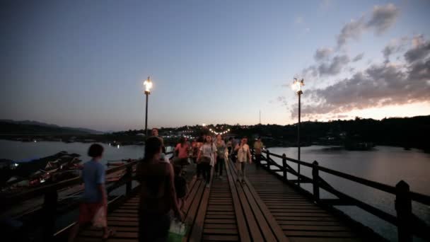 САНГХЛАБУРИ, ТАЙЛАНД - 27 ДЕКАБРЯ 2015 г.: Толпа путешественников идет по мосту Сапан Мон, утром деревянный мост через реку в районе Сангхлабури, Таиланд, 27 декабря 2015 г. — стоковое видео