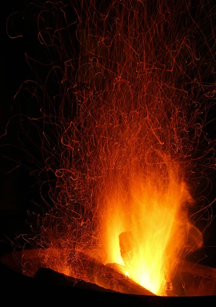 Sparks and Embers flying off a bonfire Royalty Free Stock Photos